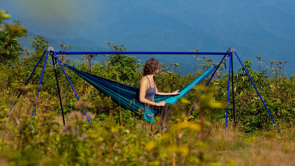 Woman sitting in ENO hammock in a field